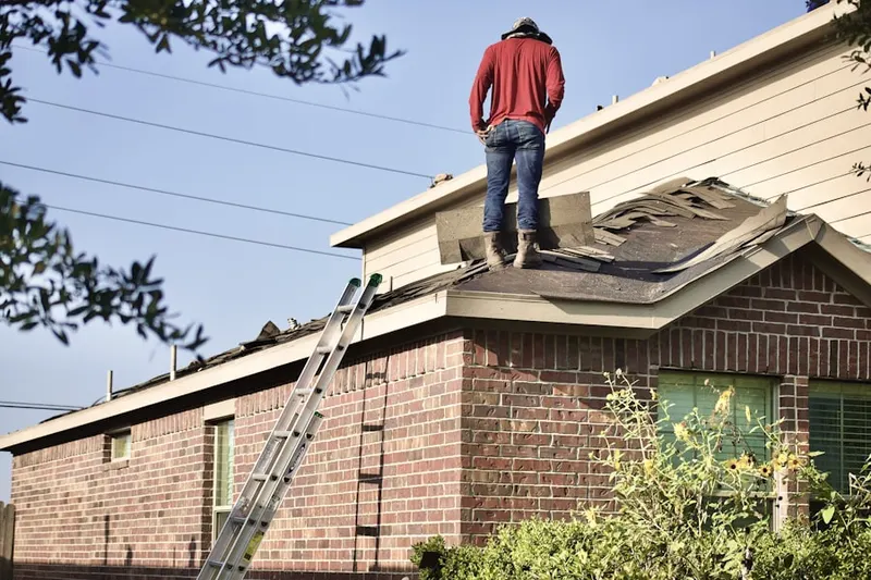 Professional roofer working on a residential roof in Willow Chase